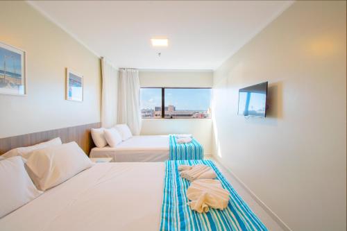 Кровать или кровати в номере Acqua Inn Maceió Ponta Verde