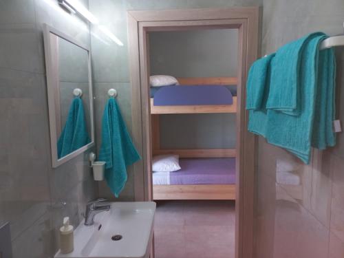 a bathroom with a sink and a bunk bed at Sandra's luxury stay in Akti Salonikiou