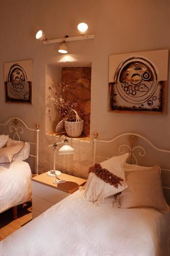 a bedroom with a bed and a table with a lamp at Casa Rústica em Alte - KARMEA HOUSES in Alte