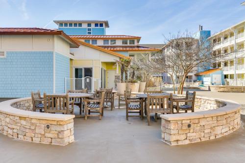 a patio with tables and chairs and a fountain at The Sanctuary - Summer Breeze A114 in Virginia Beach