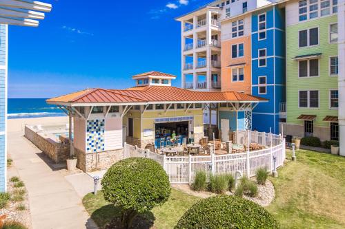an aerial view of a building with a gazebo and the beach at The Sanctuary - Summer Breeze A114 in Virginia Beach