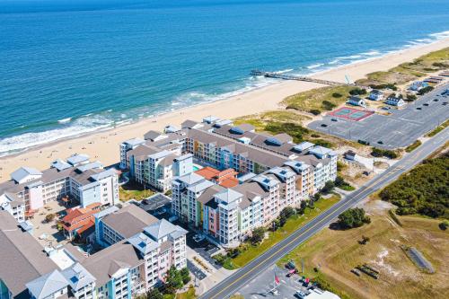 an aerial view of a beach with buildings and the ocean at The Sanctuary - Summer Breeze A114 in Virginia Beach
