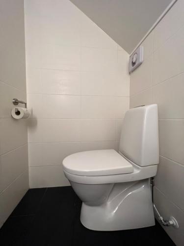 a bathroom with a white toilet in a room at Villa Bergåsa in Karlskrona