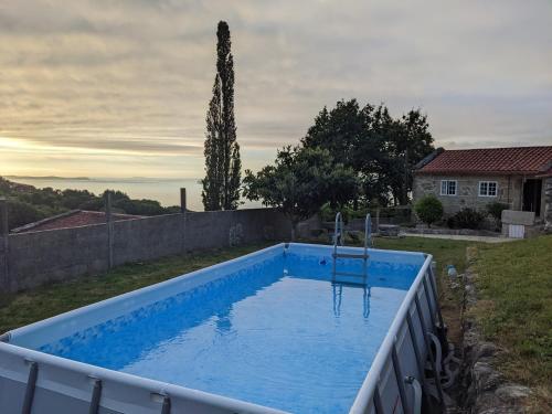 a swimming pool in the backyard of a house at Casa do Río in Bueu