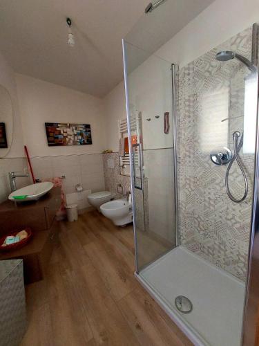 a bathroom with a shower and a toilet at Attico Panoramico Baunei in Baunei