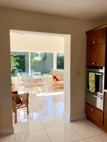 a kitchen and living room with a table and chairs at Loughgunnen Grove Lodge in Wexford