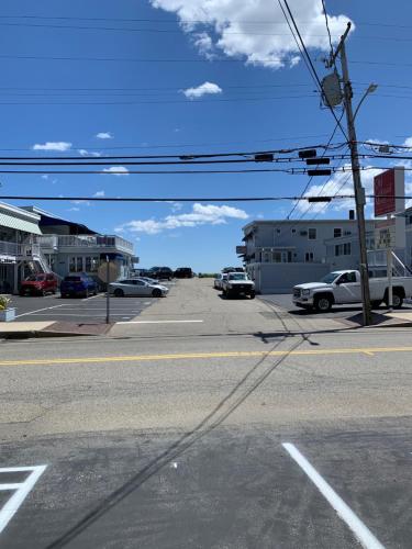 an empty street with cars parked in a parking lot at Sands Townhouses in Old Orchard Beach