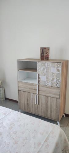 a wooden dresser in a room with a white wall at Da Anna in San Teodoro