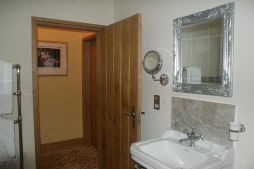 a bathroom with a sink and a mirror at Y Fan in Caerphilly