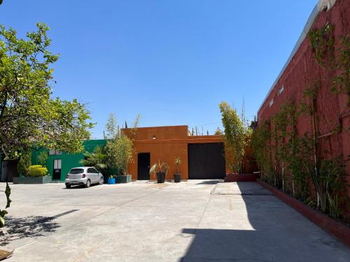 a car parked in a parking lot next to a building at Genesis Suites / Lofts in San Luis Potosí
