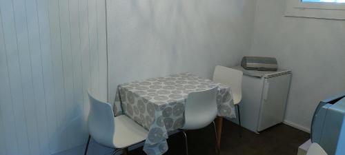 a table and chairs with a table and a printer at Chambre d'hôte L'optimisme in Montfaucon