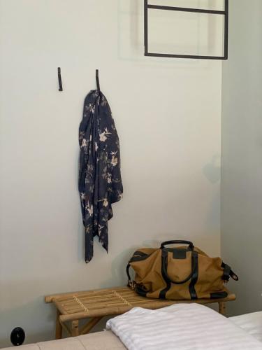 a bag hanging on a wall next to a bed at Rallarhustruns in Hässleholm