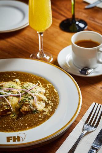 a plate of soup and a cup of coffee on a table at Fisher´s House Hotel in Avándaro