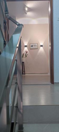 a stairway with a glass railing and a stair case at Forest Apartments in Bitola