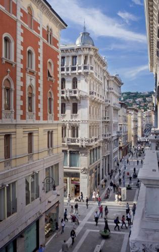a busy street in a city with buildings at Palace Suite in Trieste