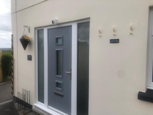 a door on the side of a building at Beacon Country House Hotel & Luxury Shepherd Huts in St. Agnes 