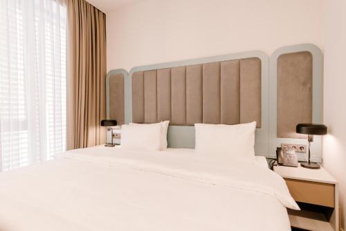 Postel nebo postele na pokoji v ubytování STROFI Boutique Hotel