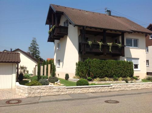 a house with a dog sitting in front of it at WiLoMa in Baden-Baden