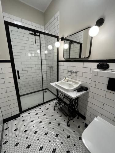 a bathroom with a sink and a shower at Lipowa Loft Apartments in Sopot