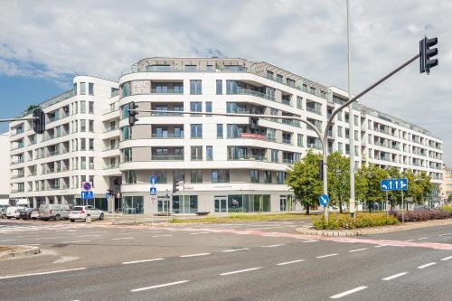 a white building on the corner of a street at Plac Unii - Premium Apartments in Gdynia