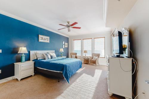 a bedroom with a bed and a blue wall at Belmont Towers 505 in Ocean City