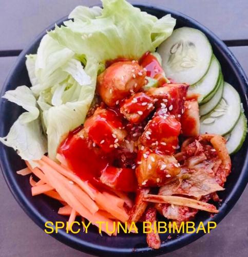 a blue plate of food with meat and vegetables at Maykenn Beach in Bantayan Island