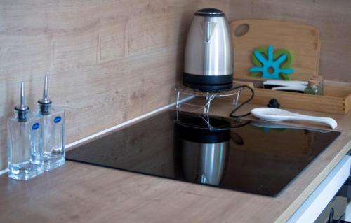 a kitchen counter with a coffee maker on a counter top at Agava sunset in Ankaran
