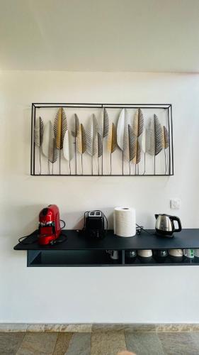 a shelf with plates and bowls on a wall at Diamond Paradise in Le Diamant