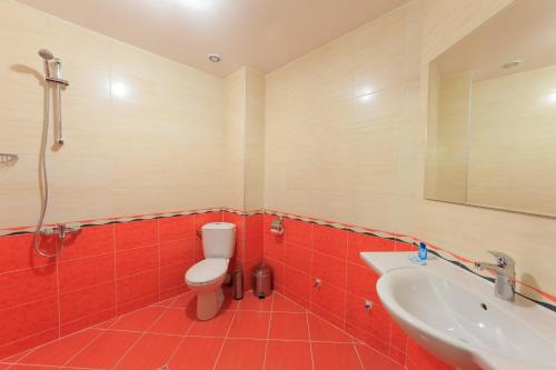 a bathroom with a toilet and a sink at Sky Hotel in Veliko Tŭrnovo