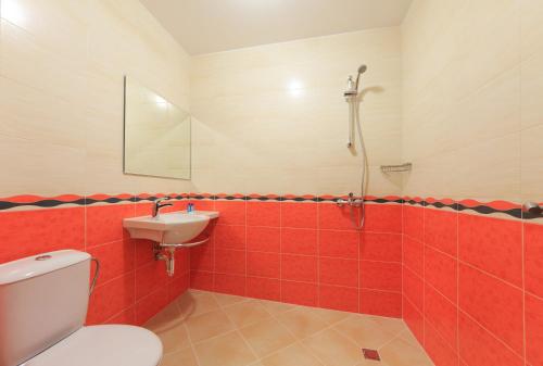 a bathroom with a toilet and a sink at Sky Hotel in Veliko Tŭrnovo