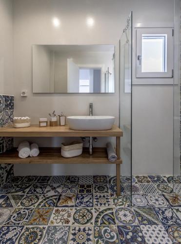 a bathroom with a sink and a mirror at Elyos Apartments in Pollonia
