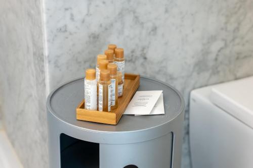 a small table with bottles of shampoo on it at Suite Bellini 5 Apartment in Palermo