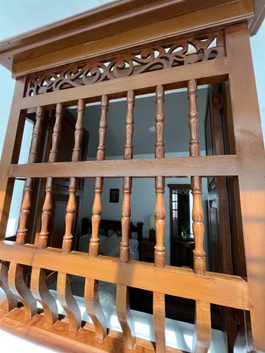 a view from the top of a wooden staircase with wood railings at Casa Grande in Medellín