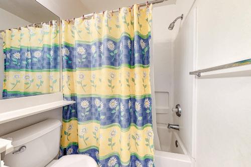 a bathroom with a shower curtain and a toilet at Sea Colony Tennis --- 55026 Pine Lake Dr in Bethany Beach