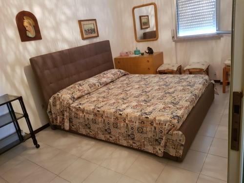 Postel nebo postele na pokoji v ubytování CONDOMINIO CESANO MARE
