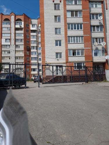 a fence in front of some tall buildings at СВІТЛО ЦІЛОДОБОВО Просторі апартаменти біля гідропарку Топільче in Ternopilʼ