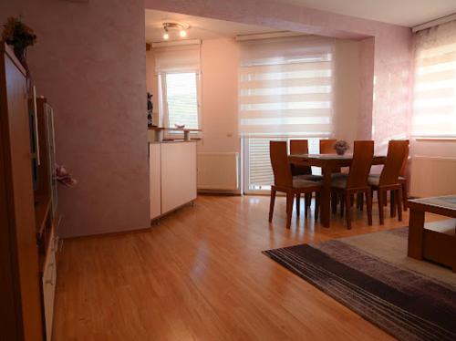 a living room with a kitchen and a table and chairs at MB Apartments in Jagodina