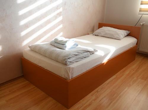 a bed with towels on it in a room at MB Apartments in Jagodina