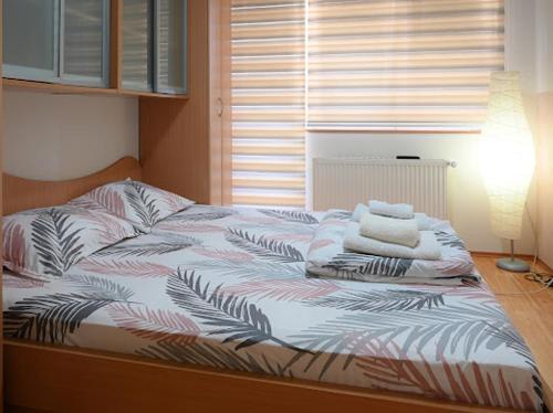 a unmade bed with towels on top of it at MB Apartments in Jagodina