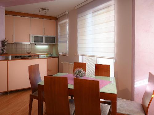 a dining room with a table and chairs and a kitchen at MB Apartments in Jagodina