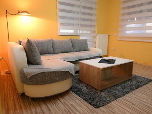 a living room with a couch and a coffee table at MB Apartments in Jagodina