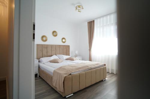 a bedroom with a large bed and a window at Casa Canadiana in Baile Felix