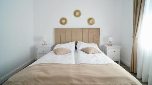 a bedroom with a large bed with two night stands at Casa Canadiana in Baile Felix