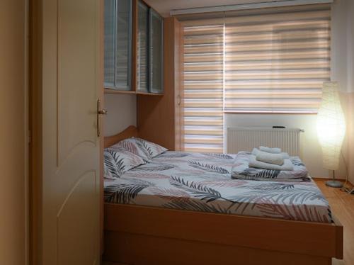 a bed with towels on it in a bedroom at MB Apartments in Jagodina