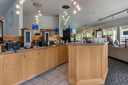 a large kitchen with wooden cabinets in a restaurant at Best Western Inn at Penticton in Penticton