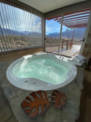 a bath tub in a room with a view at Potre casas de montaña in Potrerillos