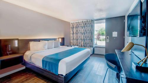 a hotel room with a bed and a window at Motel 6 Louisville, Ky- Airport/ Fair Expo in Louisville