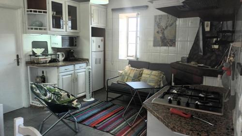 a kitchen with a stove and a stove top oven at Gerês do Alibaba in Ruivães