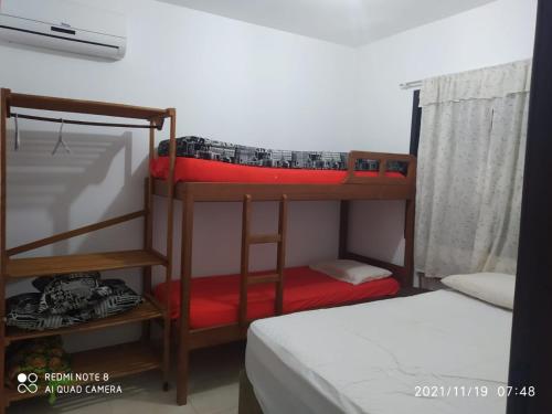 two bunk beds in a room with a bed at RESIDENCIAL CANTINHO PANTANEIRO in Itapoa
