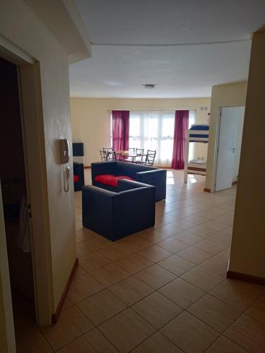 a living room with a couch and a table at Diez ApartHotel in Puerto Madryn